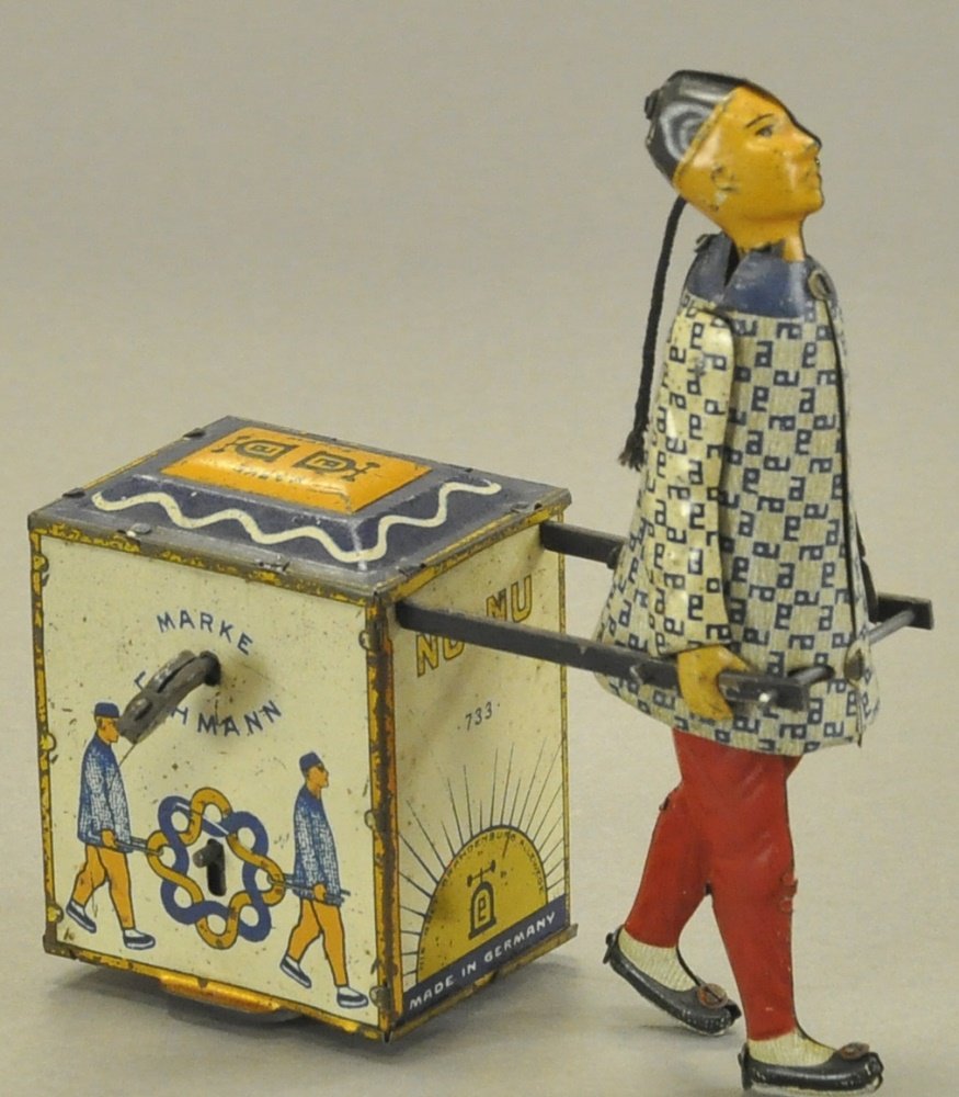 LEHMANN NU-NU: Germany, lithographed tin, colorful depiction of Chinaman pulling chest of tea, clockwork mechanism concealed within, wheels under chest allow easy motion. 5" l.