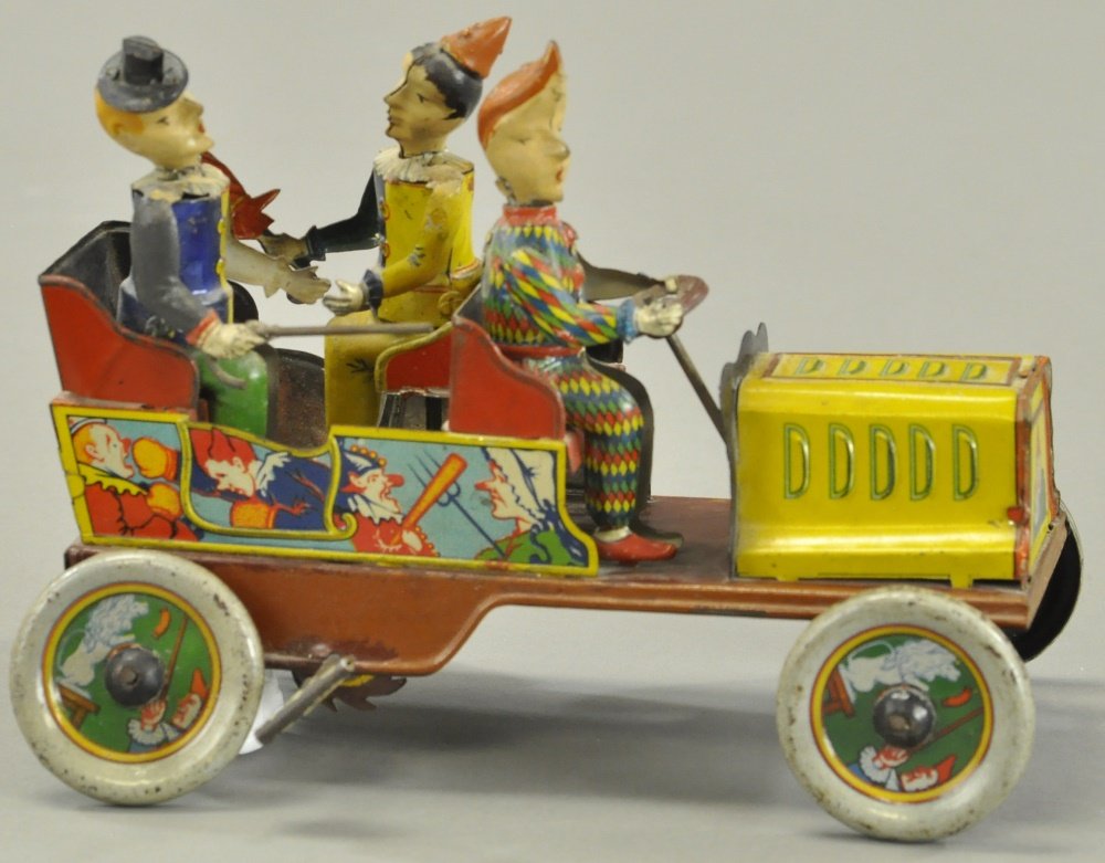 HANS EBERL TA-RA-RA-BUMM CLOWN CAR: Germany, c. 1920's, whimsical example, hand painted and lithographed tin, bright graphic images overall, open circus style car features three seated clowns, each with hand painted head, one holds umbr