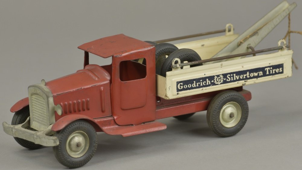 METALCRAFT GOODRICH WRECKER: c. 1930's, pressed steel, cab painted in red, railed open bed body contains boom and spare tires. 12 1/2" l.