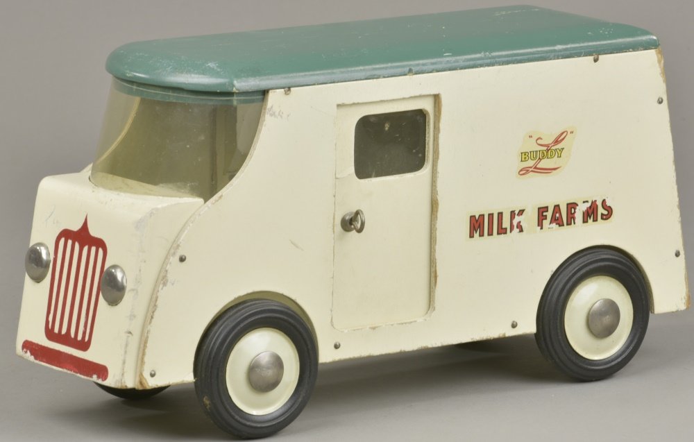 BUDDY 'L' MILK FARMS TRUCK: c. 1946, wooden truck painted in classic dairy truck white with red grille, green roof, and decals on sides. 13" l.