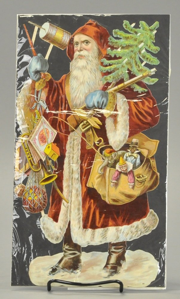 SANTA CLAUS DIE-CUT: Germany, Santa is depicted with an outstanding load of children's toys, along with a fine looking feather tree with candles, good strong color and detail throughout. 12 1/2" h.