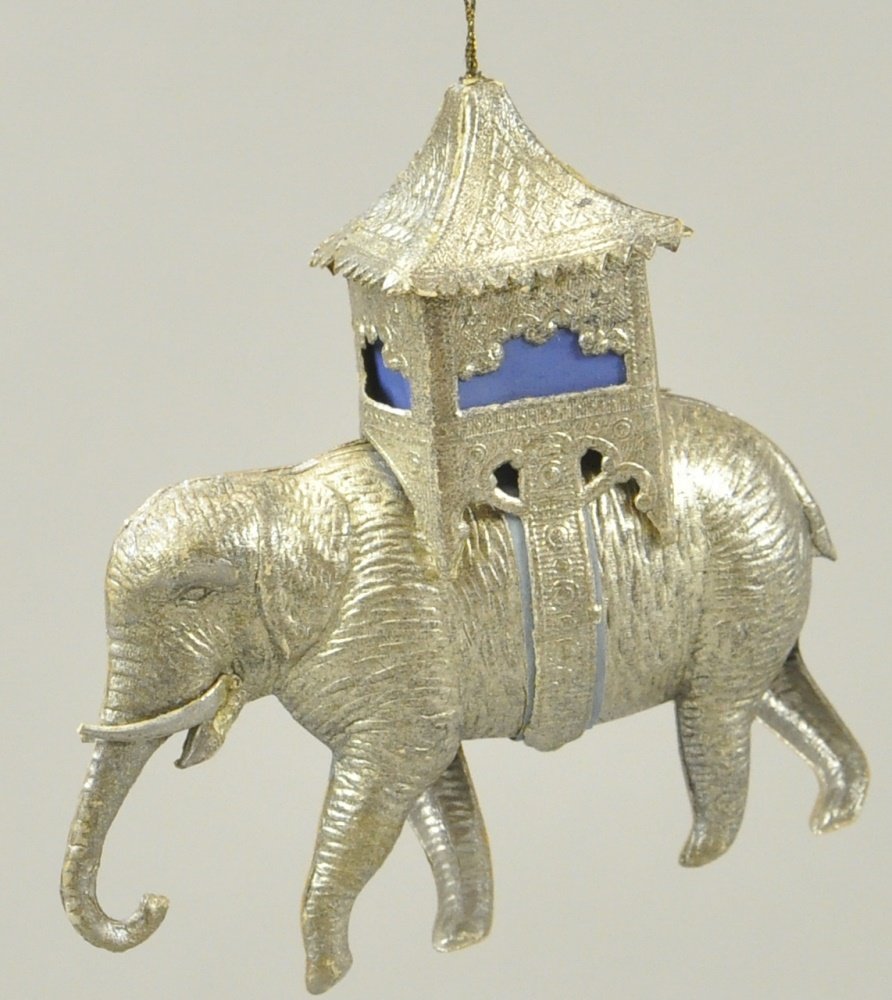 SILVER GILDED ELEPHANT WITH HOWDAH DRESDEN: The wrinkly skin of the Indian elephant, the intricate howdah with blue silk curtains, and the elaborate strap of this detailed piece exemplifies the beautiful embossed details which are typical of Ge