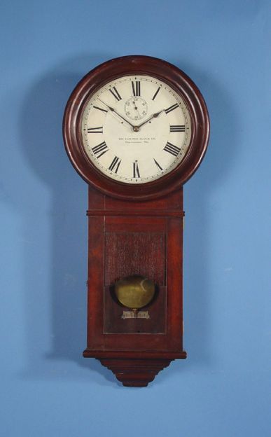Regulator Electro-Clock Wall Clock: Circa 1920 American The Electro-Clock Co. Baltimore, MD Self winding Wall Clock with 12" Painted dial, Electrically wound brass movement, Fine looking regulator wall clock in walnut case. Very good co