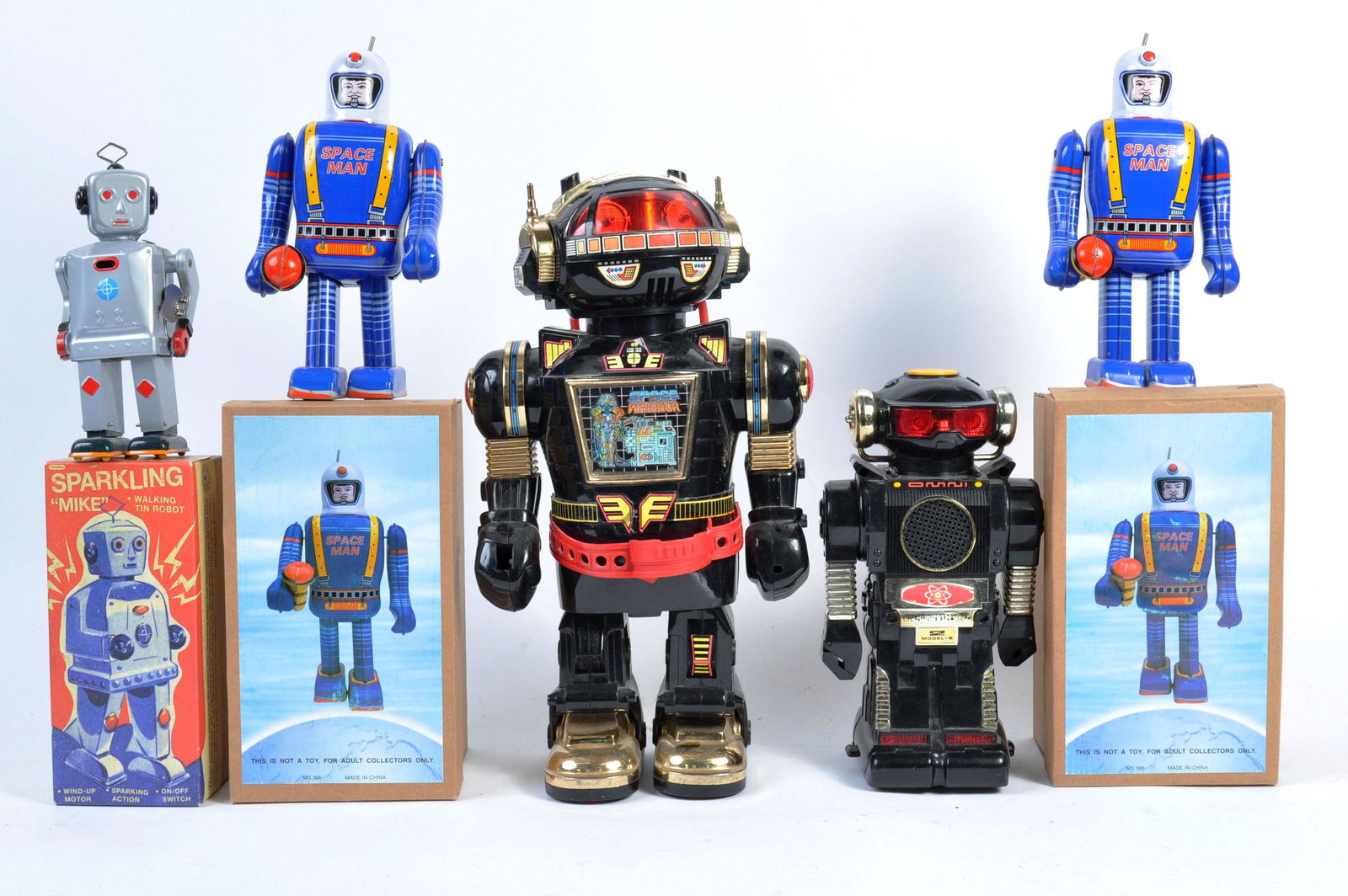 A collection of assorted toys to include; 1980's Cheng: A collection of assorted toys to include; 1980's Cheng Ching Toys Space Warrior, 1980's Tomy Mini Robot, Schylling boxed tinplate Sparkling " Mike " and 2x boxed tinplate Space Man figure.