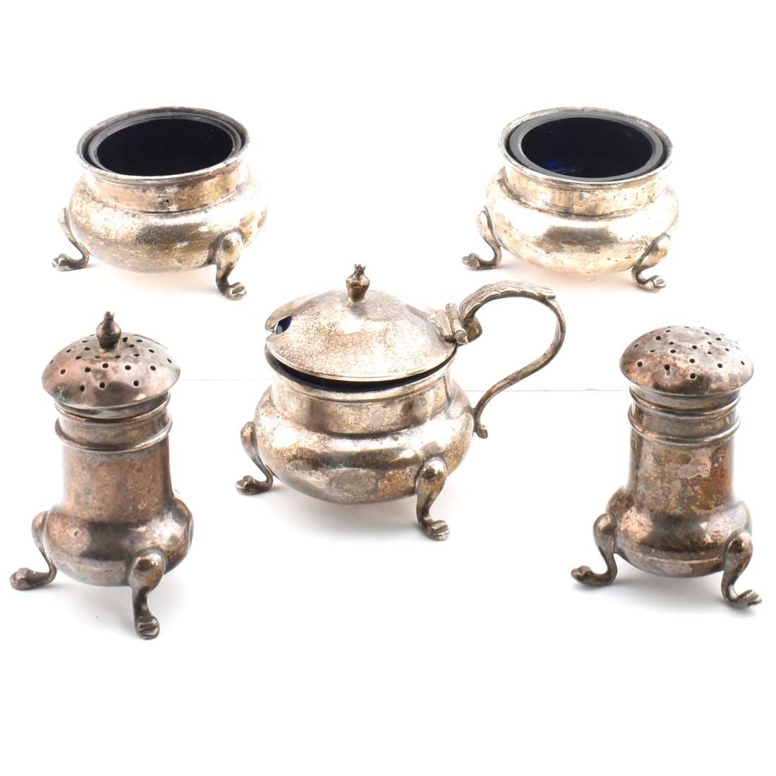 EARLY 20TH CENTURY HALLMARKED SILVER 5 PIECE CONDIMENT SET - AF: An early 20th century five piece hallmarked silver cruet set AF. The set to include two salt cellars and a mustard pot each having blue glass liners and two pepperettes. Marks only partially legible o