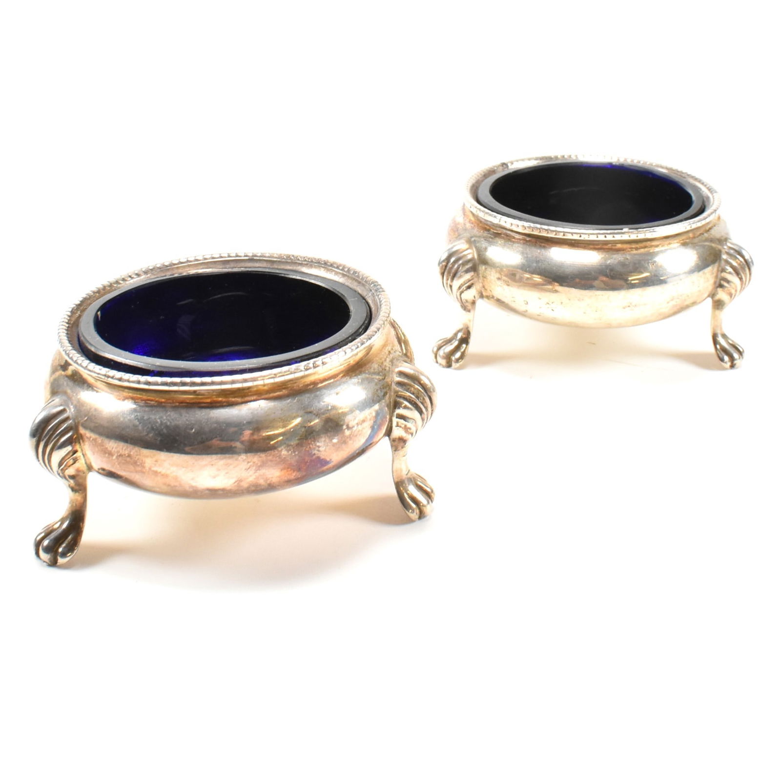 VICTORIAN HALLMARKED SILVER 19TH CENTURY LINED TABLE SALTS: A pair of Victorian hallmarked silver silver blue glass lined table salts. Hallmarked London with Queen Victorian silhouette mark. Sponsors mark RH for Robert Harper, date letter italic p