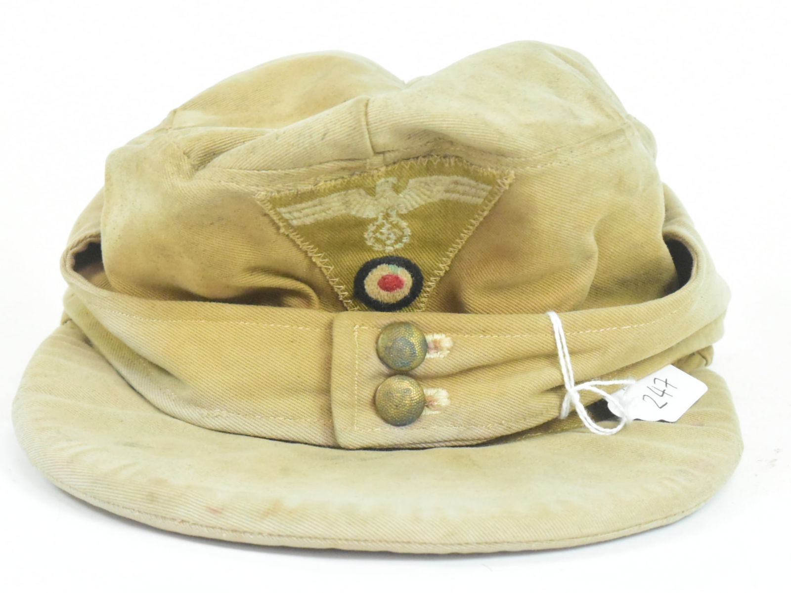 WWII SECOND WORLD WAR GERMAN AFRIKA KORPS FIELD CAP: A WWII Second World War interest Third Reich Nazi German Afrika Korps field cap. Tan / desert fabric with fold down back and sides and front applied patch with Eagle Swastika patch with tricolour roun