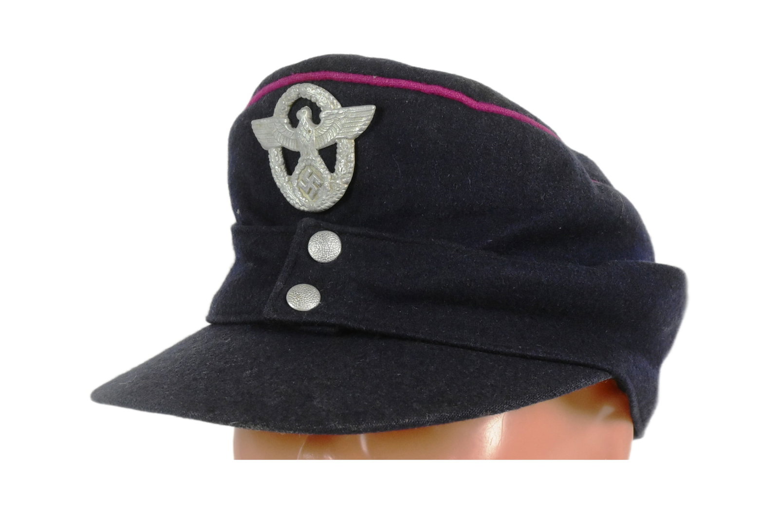 WWII SECOND WORLD WAR GERMAN FIRE OFFICERS M43 CAP: A WWII Second World War Third Reich Nazi German Fireman Officers M43 cap. Blue wool construction with pink piping, white metal Eagle Swastika badge and front button allowing the side flaps to be let d