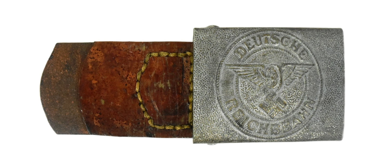 WWII GERMAN REICHSBAHN OFFICER'S BELT BUCKLE: A WWII Second World War Third Reich Nazi German Railway / Reichsbahn Officer's belt buckle. The buckle depicting a winged wheel with Swastika emblem to the centre with leather tab. Due to the nat