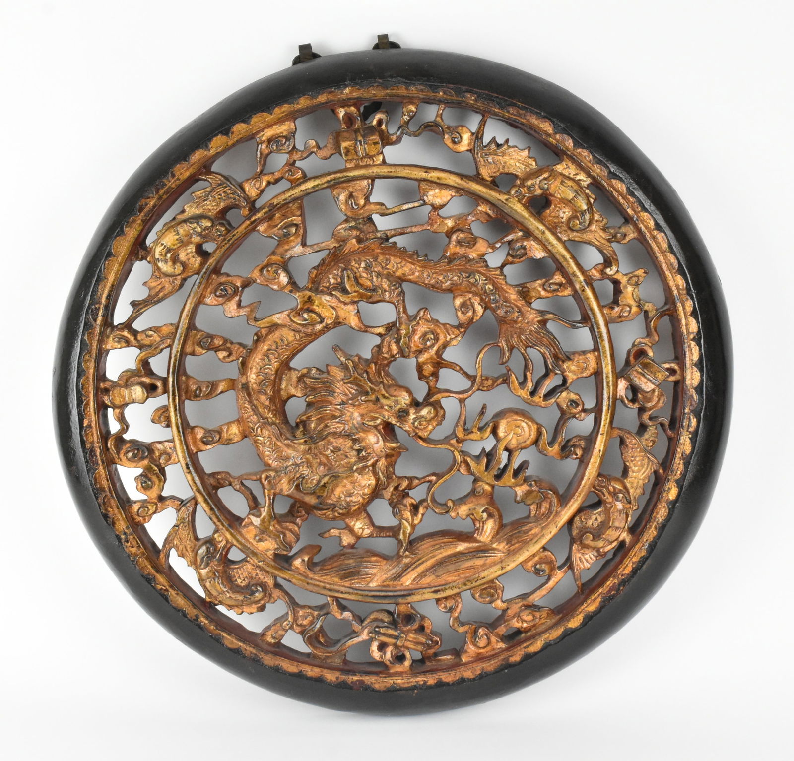 WOODEN AND GILDED "DRAGON" WALL PLAQUE 民国 木刻 龙戏珠 &#: A Republic period of hardwood open-work carved wall plaque. The wall plaque carved a large dragon chasing a flaming pearl surrounded by ruyi clouds in the centre, four dragons and antiques on the bord