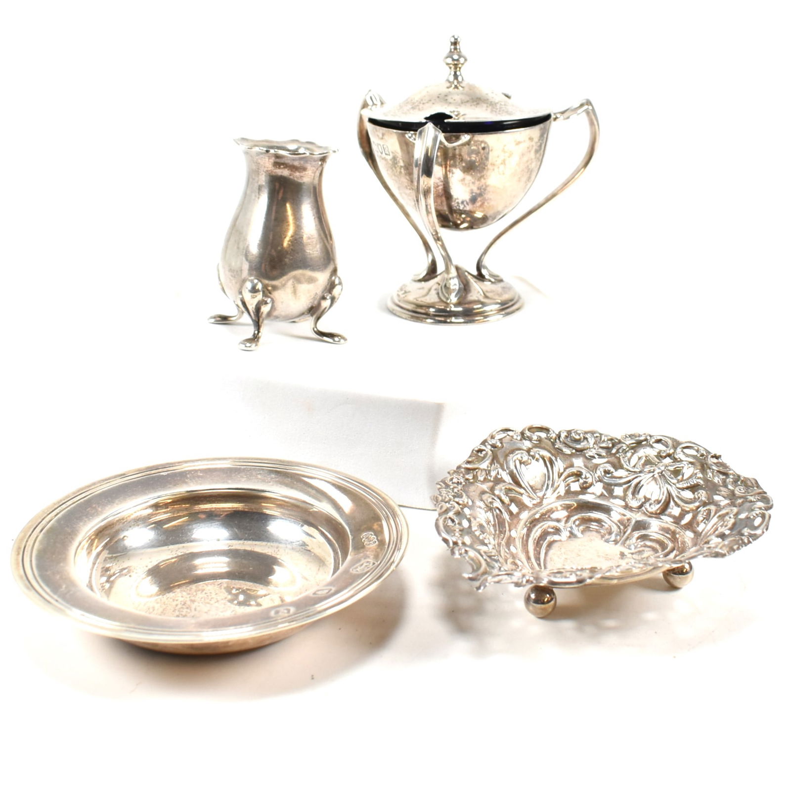 COLLECTION OF HALLMARKED SILVER DISHES & CONDIMENTS: Hallmarked silver dish, London 1971, sponsors marks for Reid & Sons Ltd. Together with 19th century pierced lattice trinket dish, hallmarked Birmingham. Also, blue glass lined condiment with three