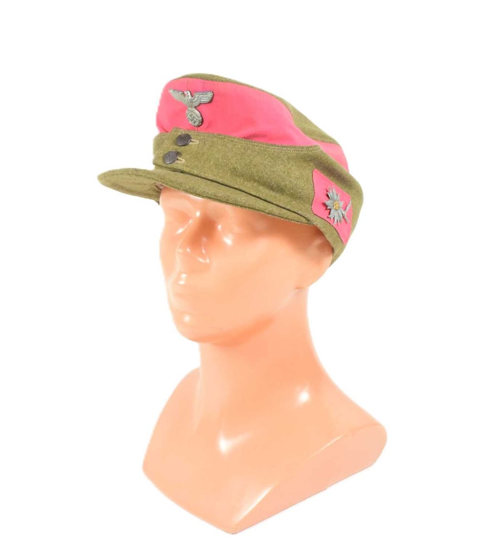 WWII SECOND WORLD WAR GERMAN SA ALPINE TROOPER M43 SKI HAT: A WWII Second World War Third Reich Nazi German SA Troopers Alpine M43 Winter Ski Cap. Green wool exterior with twill lining and a front Eagle Swastika badge and Edelweiss flower. Dated 1943. Due to t