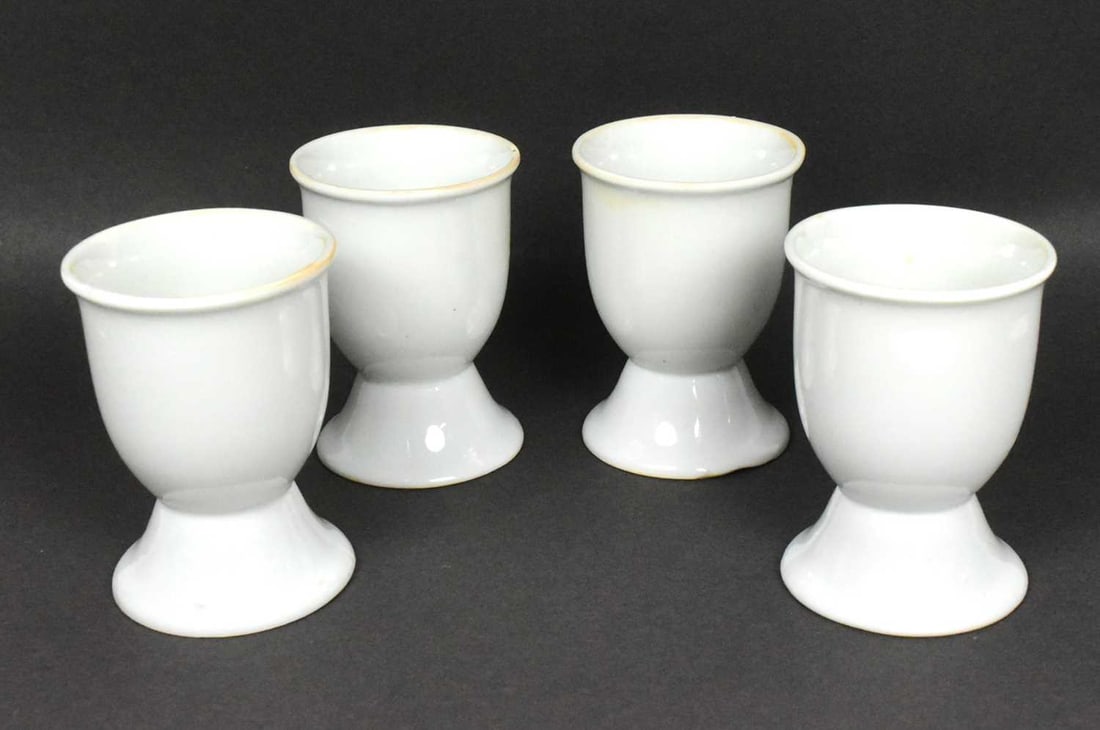 WWII SECOND WORLD WAR GERMAN KRIEGSMARINE EGG CUPS: A collection of x4 WWII Second World War Third Reich Nazi German Kriegsmarine Officers mess egg cups. White china with the bases dated 1941 below a letter ' M ' (marine) and eagle swastika motif. Due 