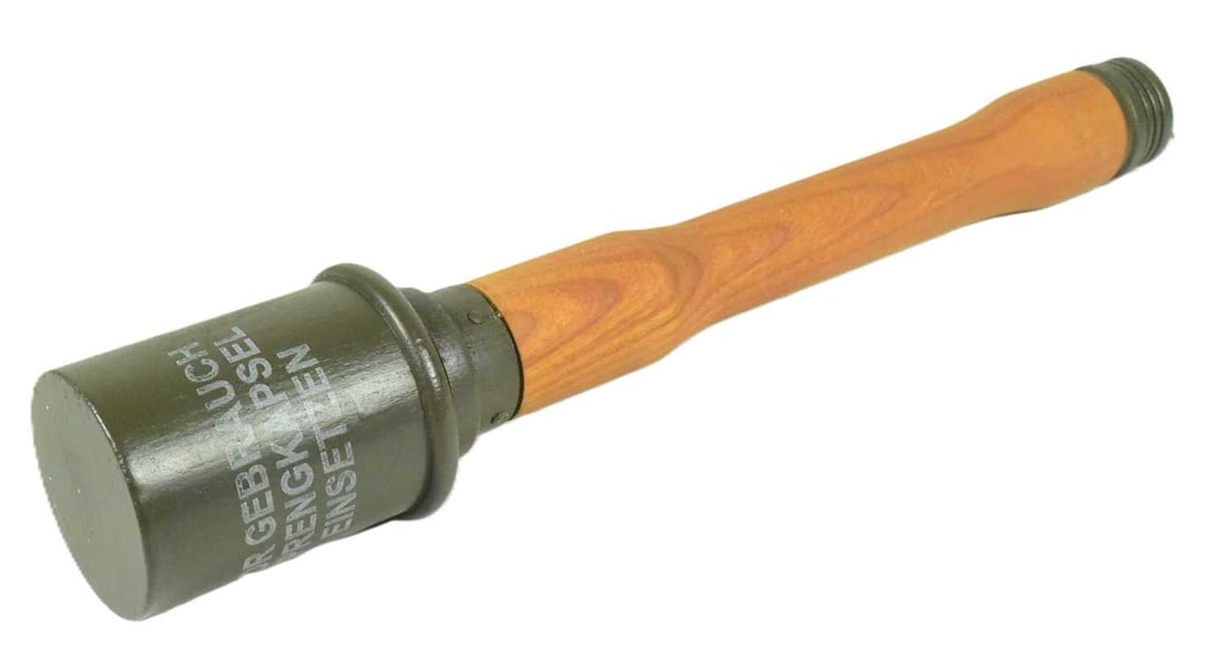 WWII SECOND WORLD WAR REPLICA M23 GERMAN STICK GRENADE: A WWII Second World War Third Reich Nazi German M23 style stick grenade. Wooden shaft with cylindrical metal head and screw cap to the base. A repainted replica example. Measures approx. 35cm.