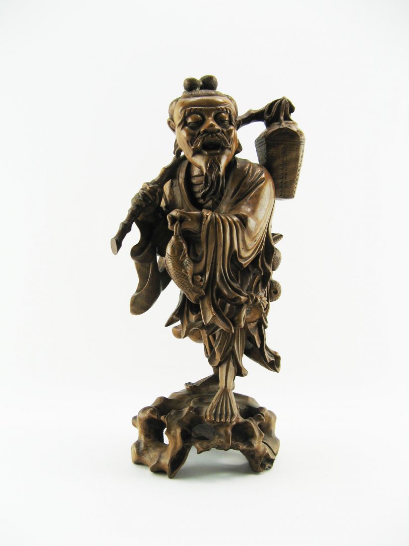 Statue: Wood, Japanese fisherman with basket on his shoulder and fish in his hand. Japan, start 20th century. Height 40 cm.Â