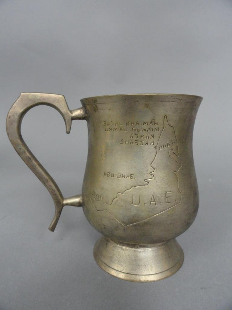 United Arab Emirates Presentation Mug: Hand tooled pewter Presentation mug With map of Arabia showing Abu Dhubi and Dubai. and a Camel on the other side 4.5" H x 3" in Dia.