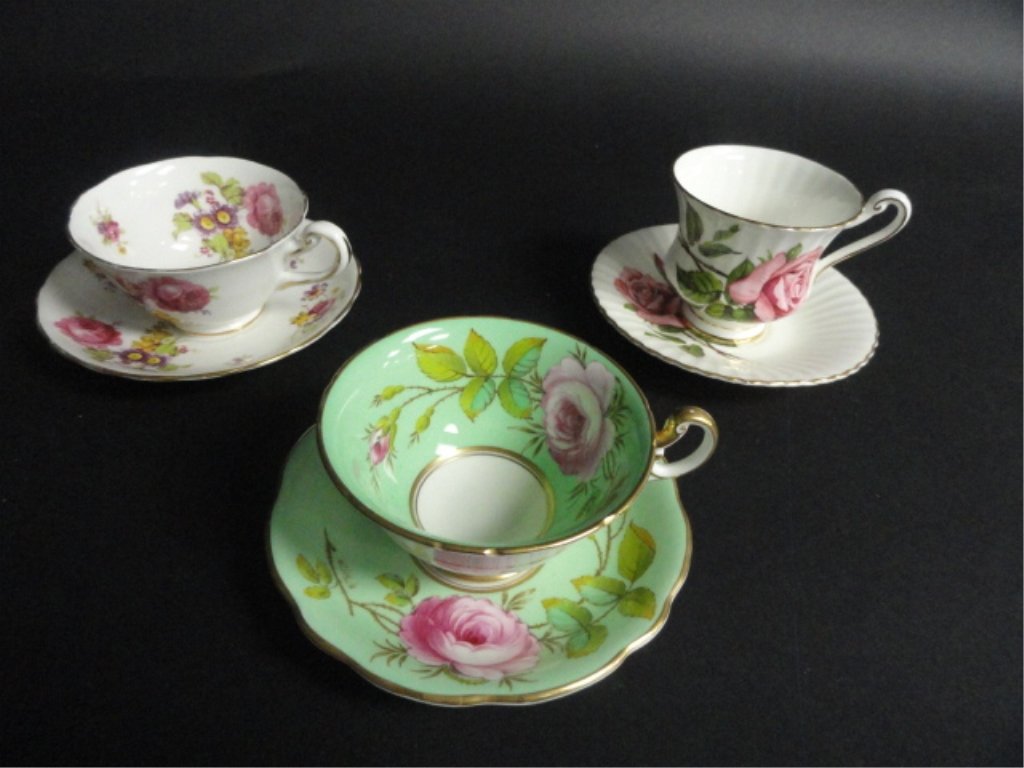 Lot of 3 Fine China Tea Cups: White cup& saucer with purple flowers makers mark Royal Chelsea English bone china, green set with pink flower markers mark Foley bone china made in England artist signed A. Taylor inside cup. white s