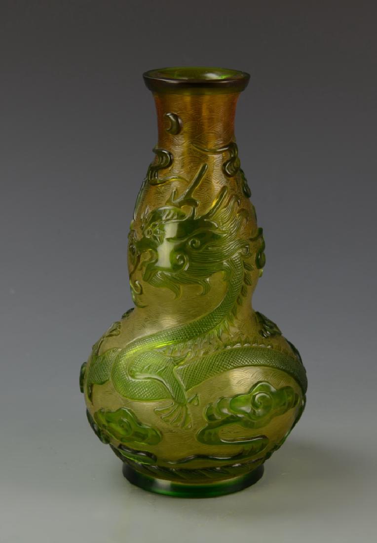 Chinese Peking Glass Vase: China, Peking glass vase, rounded lip, double gourd body on footed base, light green dragon and ruyi clouds wrapped around the body with pale yellow ground, mark on base. Height 10 in.