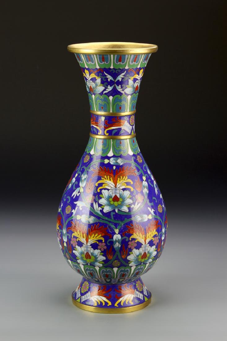 Chinese Cloisonne Vase: China, cloisonne vase, with a bulbous body, tapered neck, and flared rim, with scrolling stylized floral motifs across the surface, in bright hues. Height 14 3/4 in.