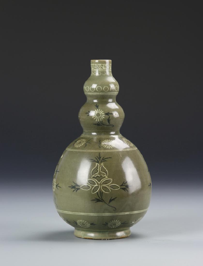 Korean Antique Vase: Korea, antique vase, small mouth, double gourd neck, bulbous body on footed base, olive green ground with simplistic floral design and borders. Height 8 1/4 in.