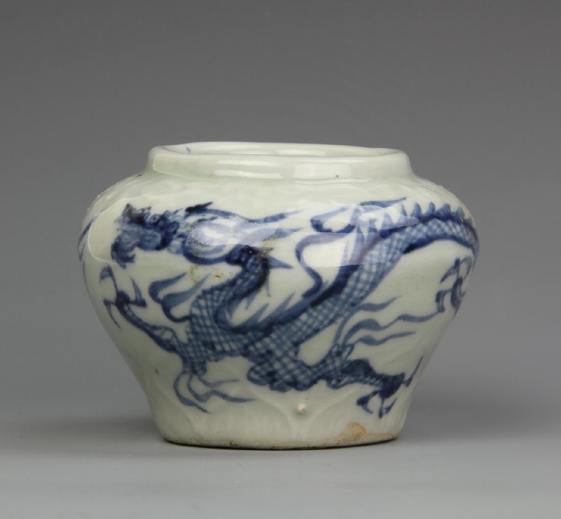 Chinese Blue and White Jar: China, blue and white jar, with a high rounded shoulder and large opening, flat base, and a large scrolling dragon motif across the body. Height 2 1/2 in.