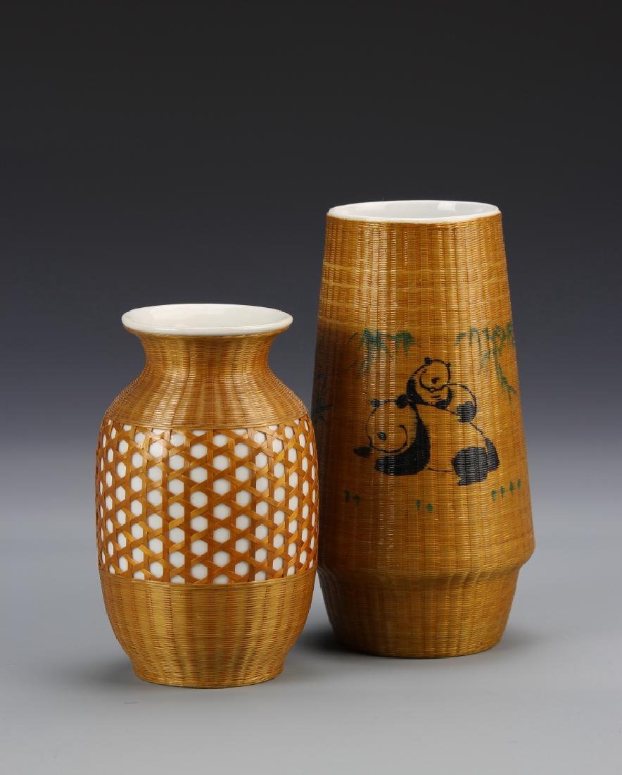 Two Chinese Porcelain Vases: China, two porcelain vases, white glazed, with bamboo coverings, one with detailed painted panda motifs, the other with open work weaving across the body. Largest Height 6 1/2 in.