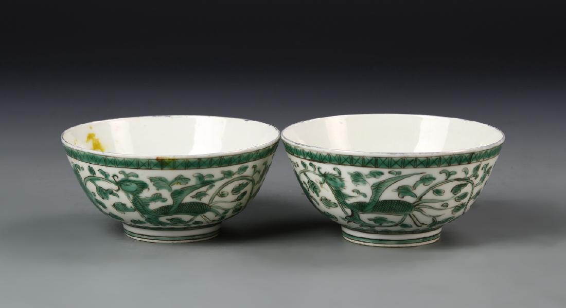 Pair of Chinese Green Glazed Bowls: China, 19th C., pair of green glazed bowls, each on a raised base, glazed in a white ground, decorated with a dragon design painted in forest green, with white glazed interior, with yellow mark on int
