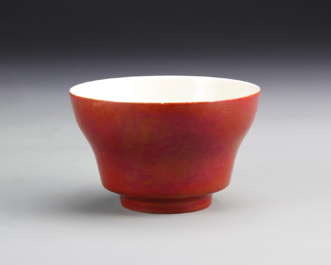 Chinese Ox Blood Glazed Bowl: China, 19th C., ox blood glazed bowl, on a raised base, with a solid white interior, and smooth surface, with high shine, mark on base. Height 3 1/8 in., Diameter 2 1/4 in.