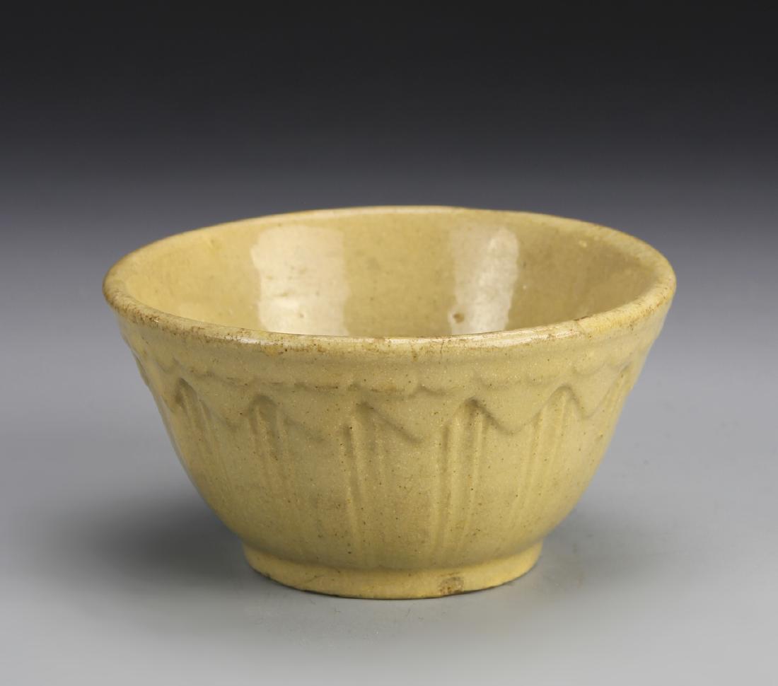 Chinese Antique Dark Cream Glazed Bowl: China, antique dark cream glazed bowl, carved triangular pattern circling the rim. Dimensions 4 1/2 x 2 3/4 in.