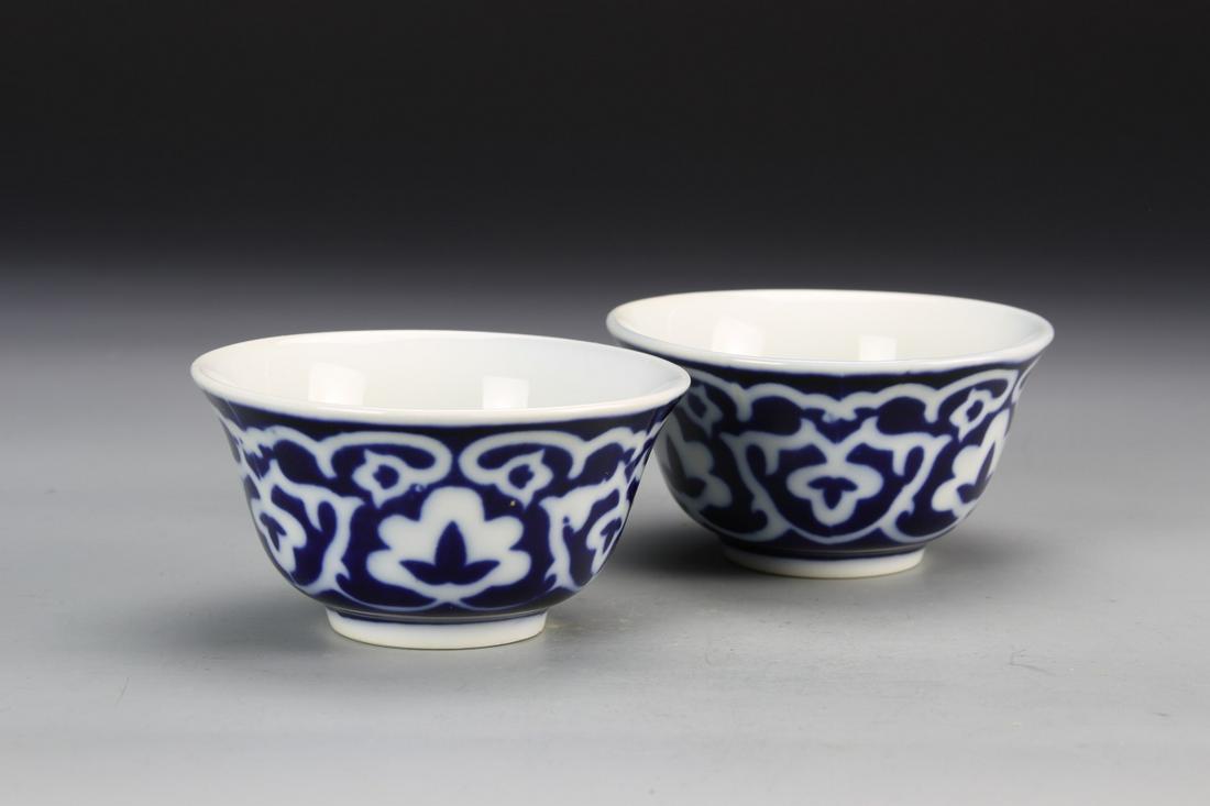 Pair of Chinese Antique Blue and White Bowls: China, a pair of antique blue and white bowls, with pedestal base, flared rim, and stylized floral motifs across the surface. Width 4 1/2 in., Height 2 1/4 in.