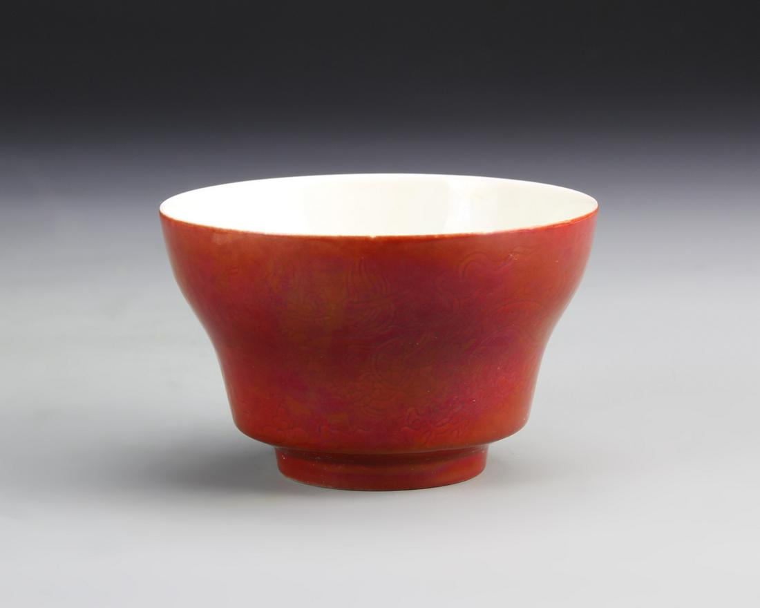 Chinese Ox Blood Glazed Bowl: China, 19th C., ox blood glazed bowl, on a raised base, with a solid white interior, and smooth surface, with high shine, mark on base. Height 3 1/8 in., Diameter 2 1/4 in.