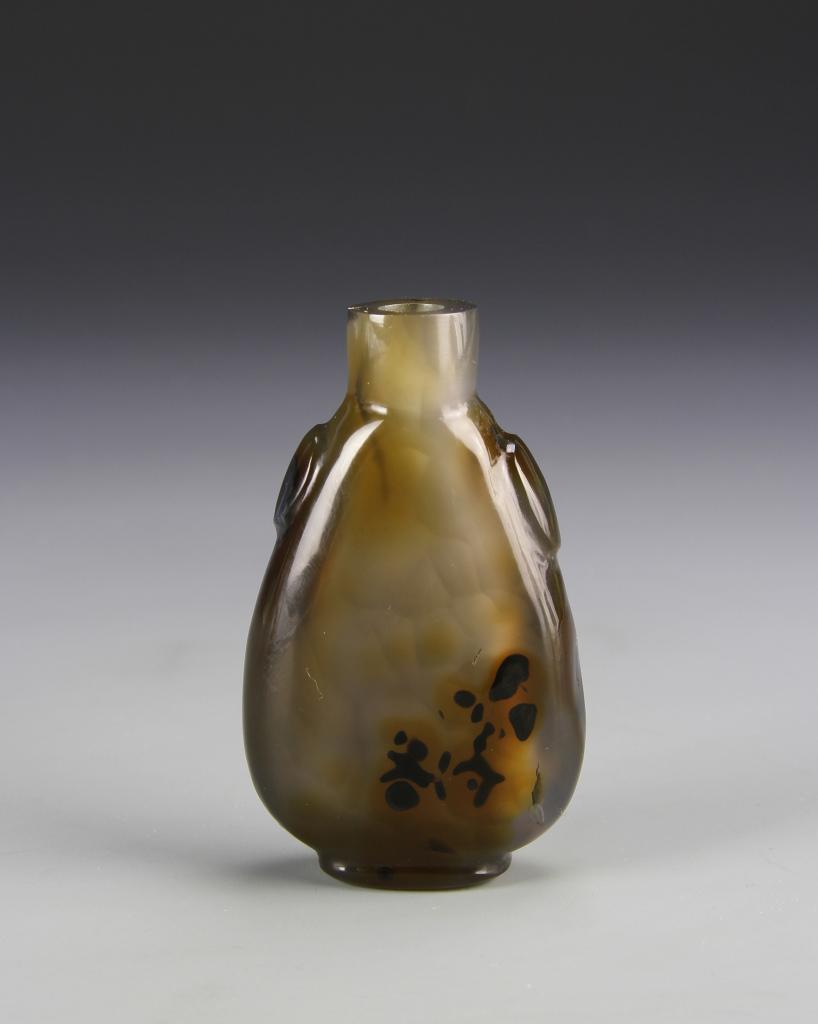 Chinese Agate Snuff Bottle: China, ROC Period, agate snuff bottle, in a tall slender form with round protrusions below the neck, in a pale brown hue with mottles. Height 2 1/2 in.