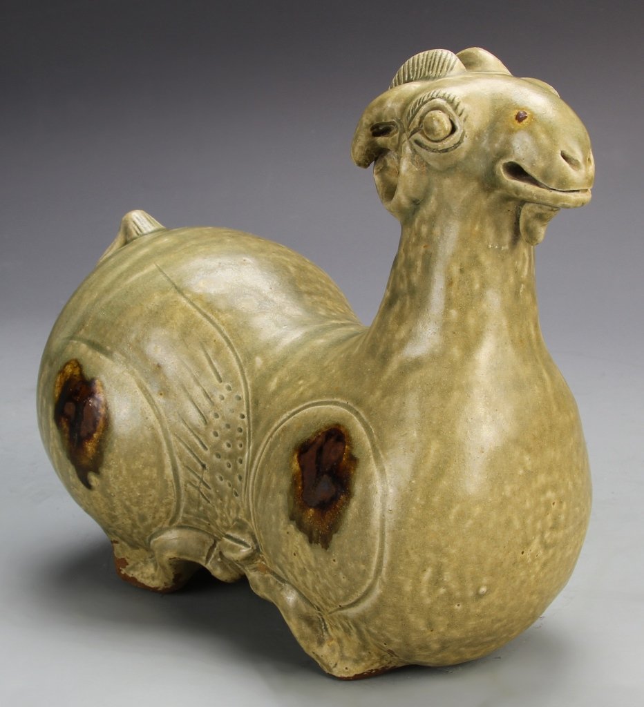 Chinese Yue Ware Ram: China, Yue ware figure of a ram in a laying position, with speckled green coloring. Height 4 3/4 in., Length 7 in.