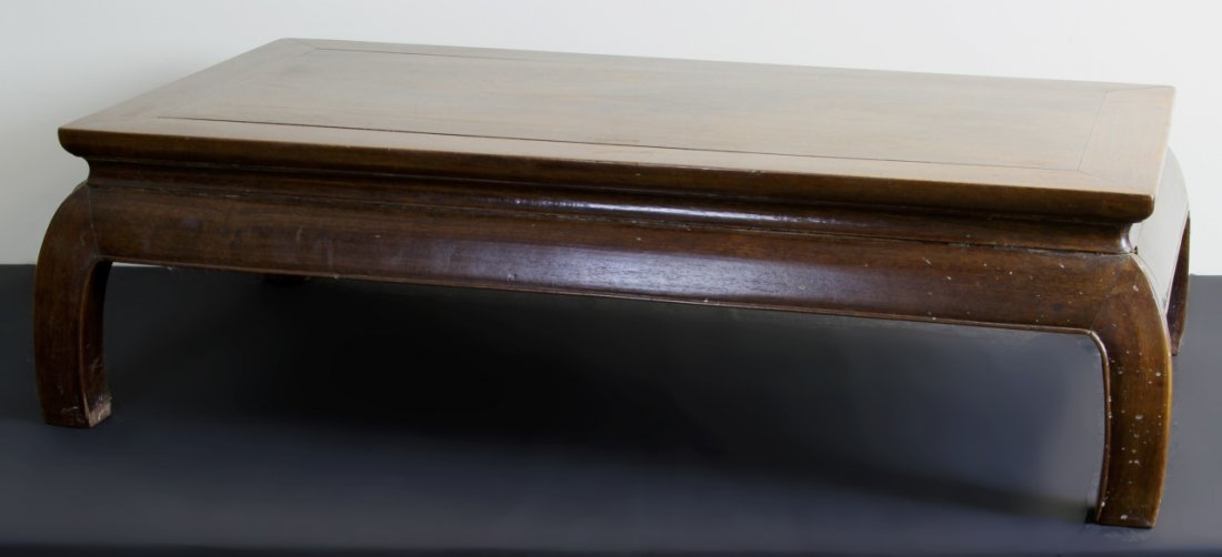 Chinese Huanghuali Kong Table: China, 19th C., Huanghuali Kong table, in a low form, with traditional minimalist carving, curved legs and hoofed feet. Height: 11 in., Width: 33 in., Length: 19 in.