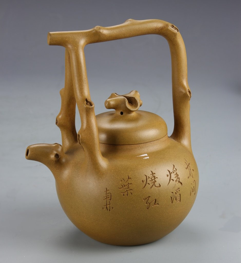 Chinese Yixing Teapot, Signed Jing Ding Shang: China, Yixing teapot, in a rounded form, with a tripod form tree-branch handle, signed Jing Ding Shang. Height: 7 1/4 in., Width: 5 1/5 in.