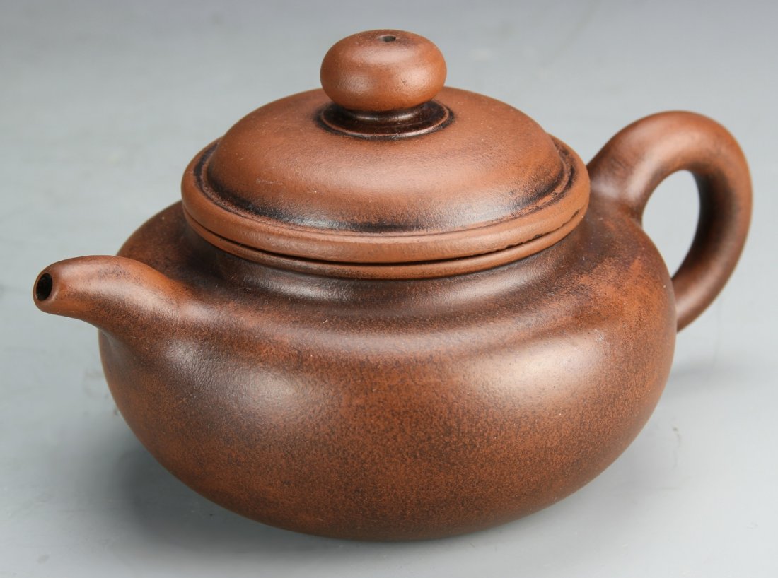 Chinese Yixing Teapot, Signed Gu Jinzhou: China, Yixing teapot in a rounded bulbous form, with a lovely speckled finish, signed Gu Jin Zhou. Height: 2 1/4 in., Width: 7 1/2 in.
