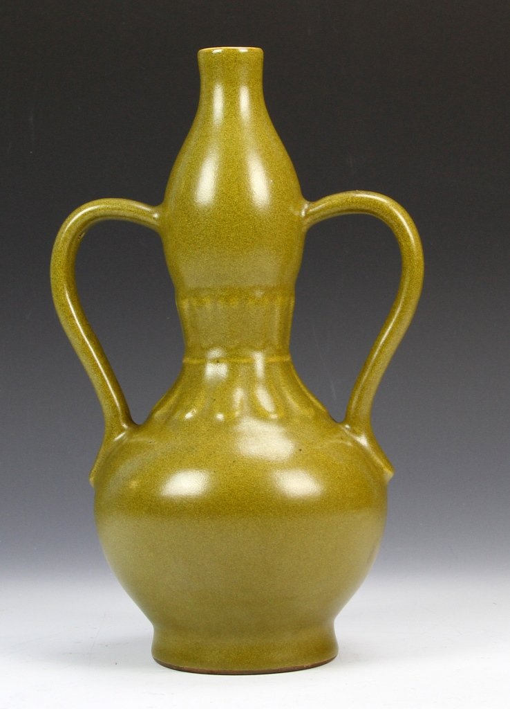 Chinese Teadust Glazed Wine Bottle: China, 19th C., teadust glazed wine bottle with two protruding handles, mottled olive green in color, Qianlong mark on base. Height 10 1/2 in.