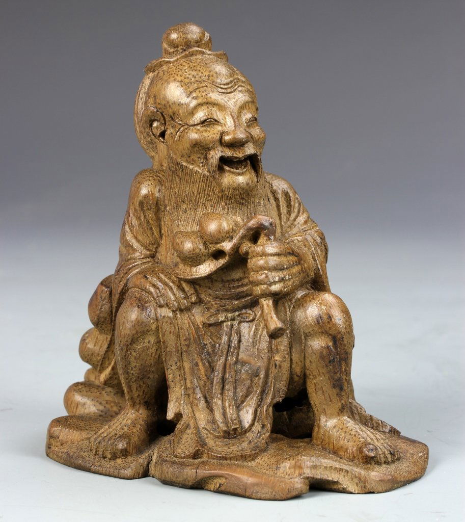 Chinese Carved Bamboo Soulai Figure: China, carved bamboo Soulai figure, in a seated position with flowing robes and a happy facial expression. Height 4 in.