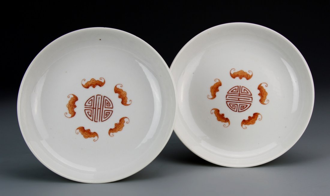 Two Chinese Famille Rose Plates: China, two Famille Rose plates with naturalistic floral motifs and medallions of calligraphy characters on exterior, bats and auspicious symbols depicted on interior, Qianlong marks. Diameter 6 1/2 in