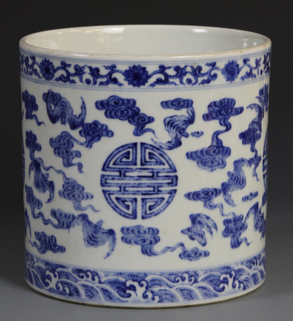 Chinese Blue and White Brush Pot: China, 19th C., blue and white brush pot decorated with bats and happiness motifs with a band of ocean waves and a band of flowers, Qianlong mark on base. Height 6 1/4 in., Width 6 in.