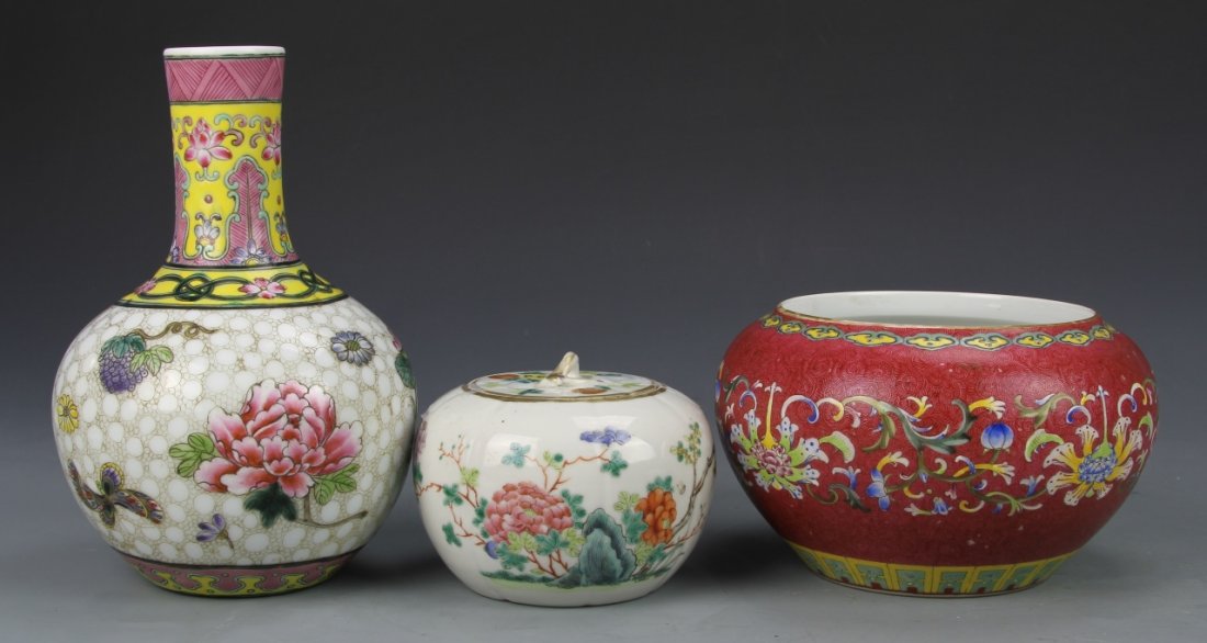 Three Chinese Famille Rose Pieces: China, three Famille Rose pieces; one vase, one covered jar, and one water pot, all featuring brightly painted decorations of peonies and other floral patterning, each posses mark on base. Height of l