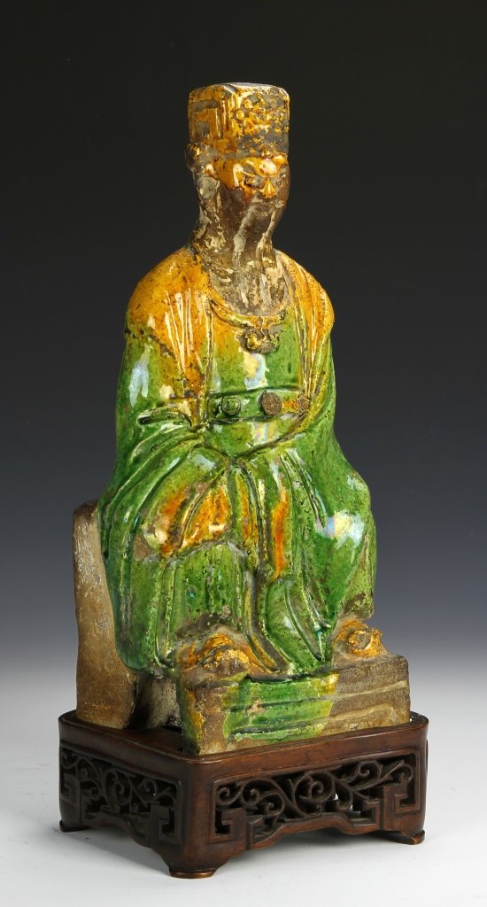 Chinese Green Glazed Wiseman Figure: China, Ming Period, glazed wise man figure, in a seated position wearing a rich robe of green, on a carved wooden base. Height 14 1/2 in.