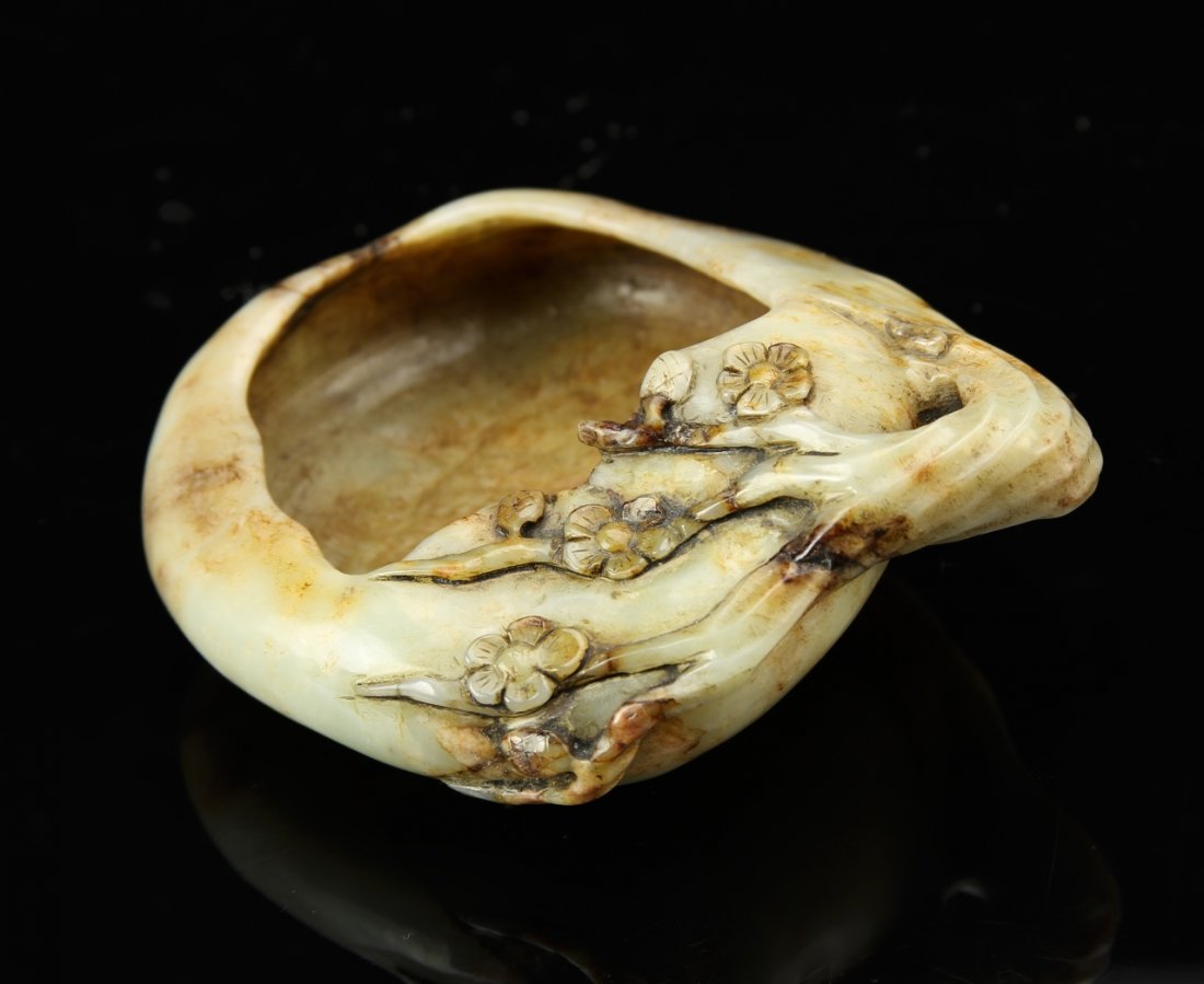 Chinese 18th Century Jade Brush Washer: China, 18th C., jade brush washer, carved with a naturalistic tree branch and blossoms along one edge, in a mottled white and brown hue. Diameter 3 7/8 in.