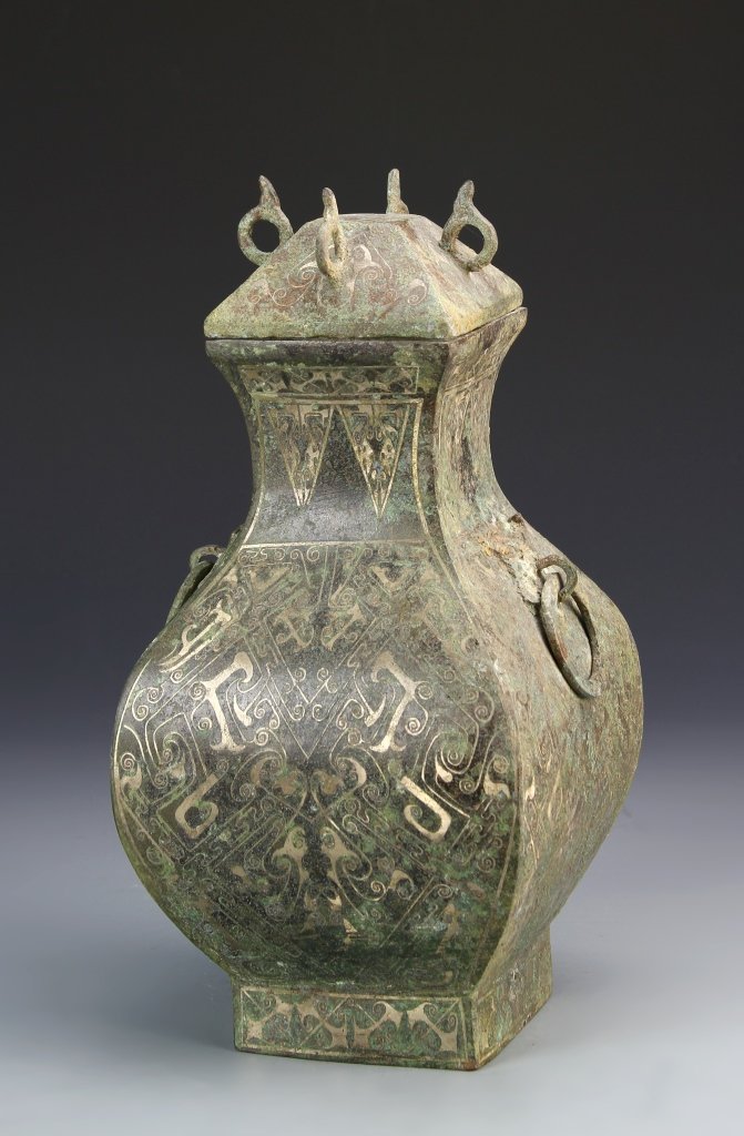 Chinese Han Dynasty Bronze Vase: China, Han Dynasty, bronze vase, elaborately decorated vase, gilt paint, with auspicious symbols and geometric designs, with ring handles,with cover, heavy patina. Height 12 in.