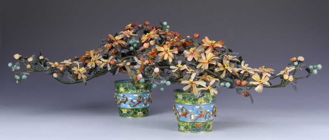 Two Chinese Jade and Stone Flowers with Planters: China, two jade and stone flowers pots with red and yellow flowers and detailed buds and leaves, with blue and green cloisonne planters with colorful geometric designs. Height 8 1/2 in.