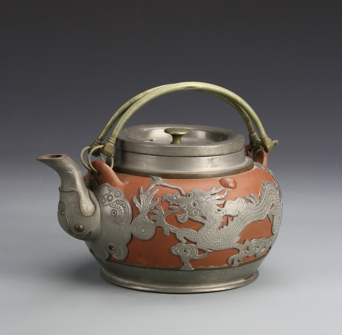 Chinese Yixing Teapot with Metal Work: China, Yixing teapot with metal work, with elephant head spout, detailed dragon motif, and carved details, mark on base. Width 4 in., Length 7 1/2 in.