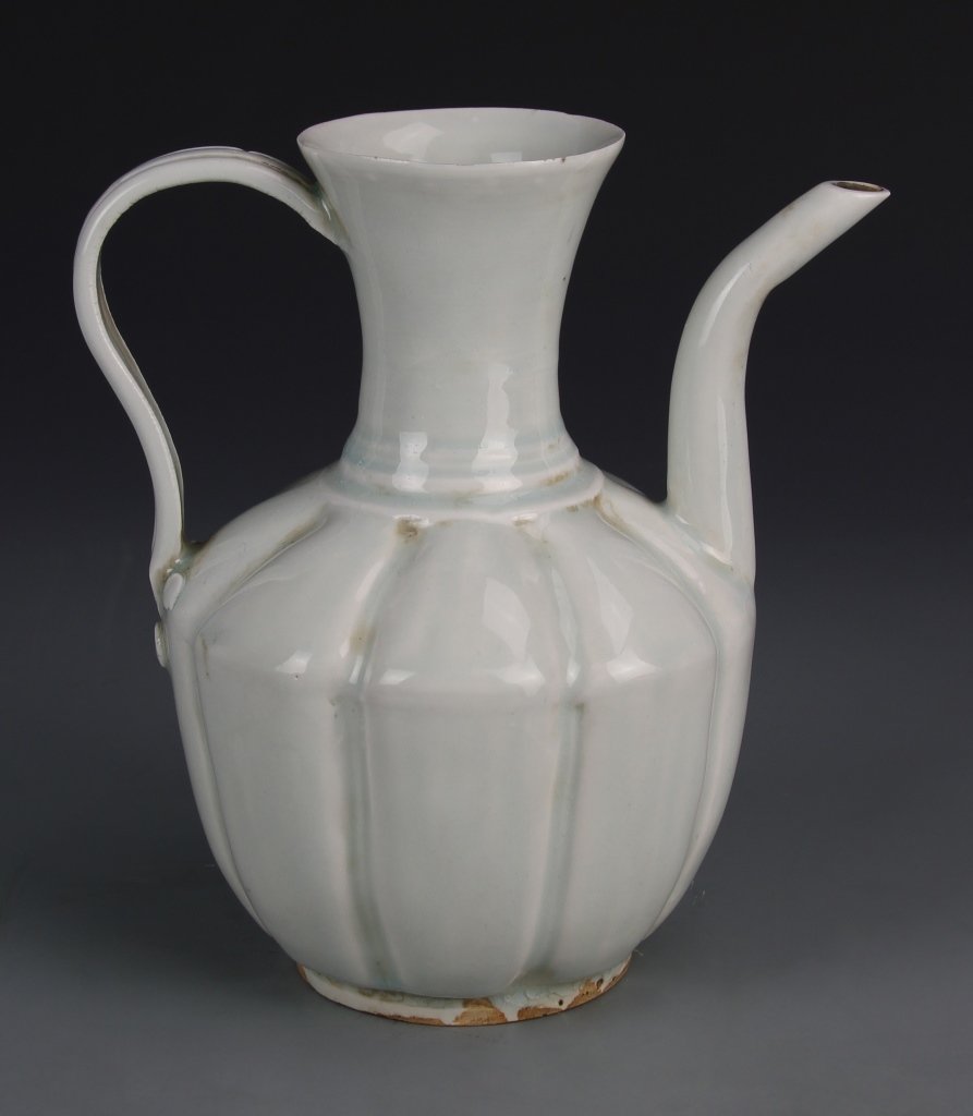 Chinese Qingbai Ware Wine Pot: China, Qingbai ware wine pot, short flat foot, bulbous body tapering shoulders to a narrow neck with flouted rim, long thin spout and handle. Height 7 1/2 in.