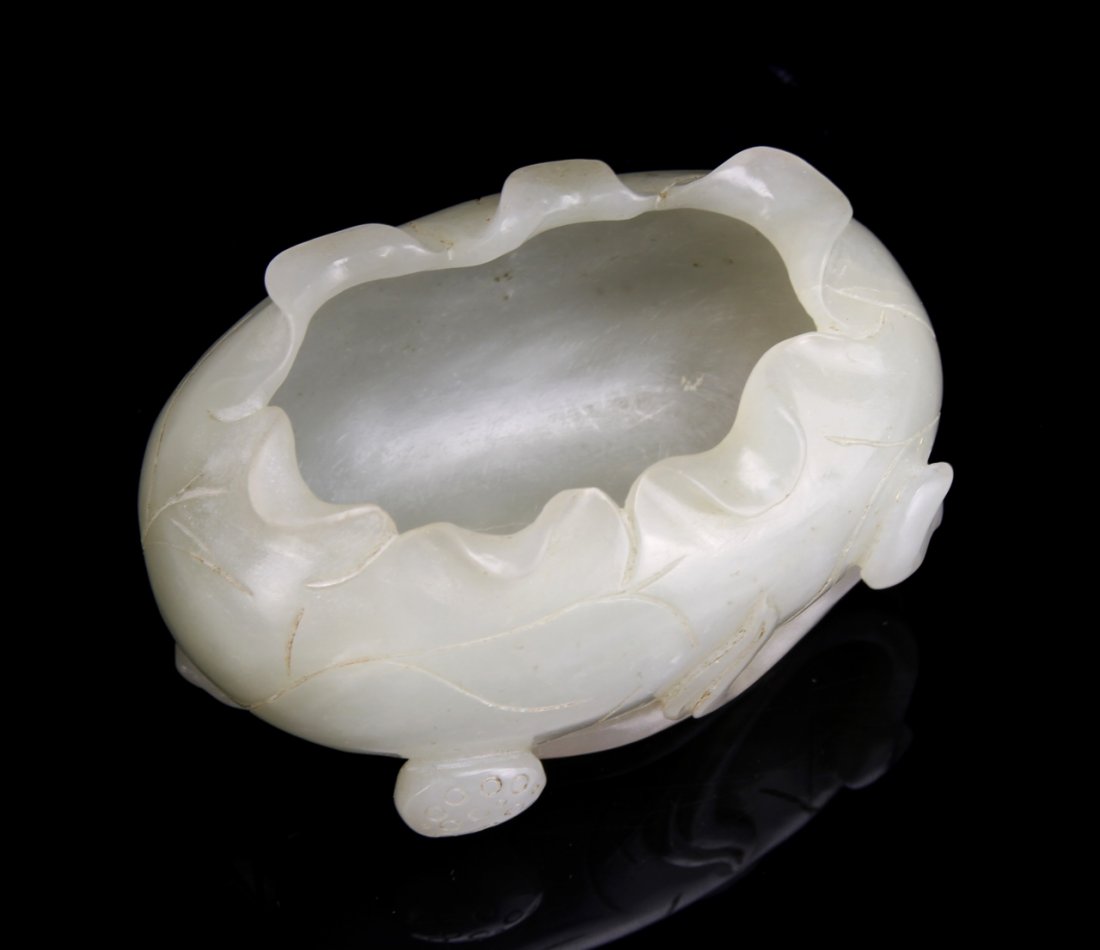 Chinese Jade Brush Washer: China, 19th C., jade brush washer, carved leaves as the base, intricately flared rim. Length 3 1/4 in., Width 1 3/4 in.