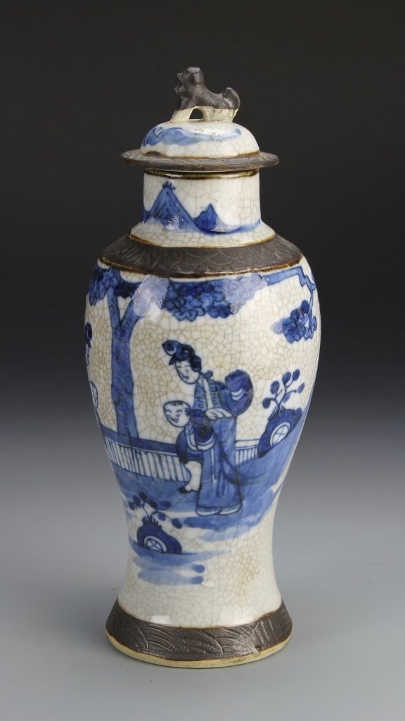 Chinese Blue and White Vase with Cover: China, 19th C., blue and white vase with cover, brown detailed ring encircling base, shoulder, and topper, painted detail of figures in a natural setting on body, mark on base. Height 10 1/2 in.