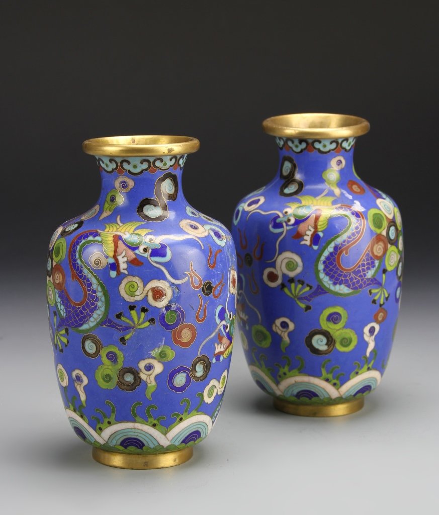 Pair of Chinese Cloisonne Vases: China, ROC Period, a pair of cloisonne vases, blue ground decorated with brightly colored scrolling dragon figure against floral designs, CHINA mark on base, enamel loss and dents. Height 6 1/4 in.